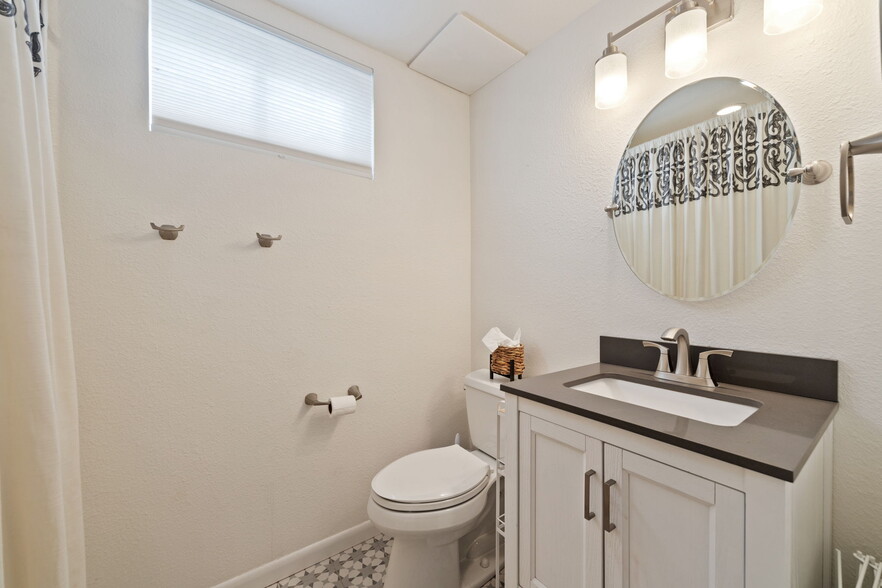 Additional bathroom in the basement with modern amenities. - 3418 Stratton Dr