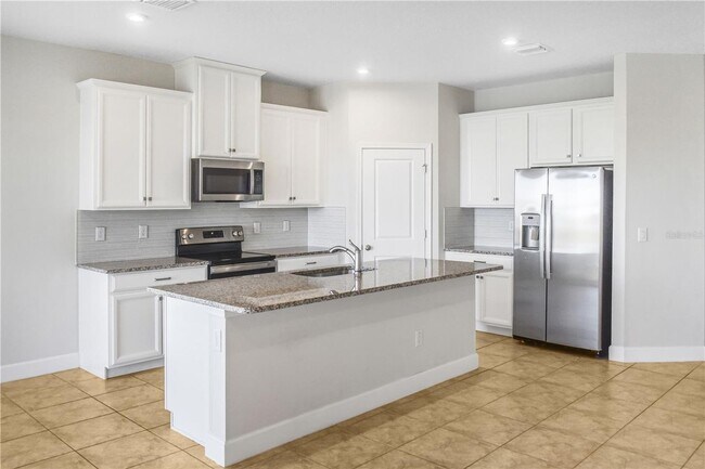 Building Photo - Open concept home offering four bedrooms, three baths, a two car garage and open lanai.