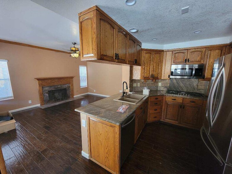 Kitchen + Downstairs Fireplace Area - 28045 Magic Mountain Ln