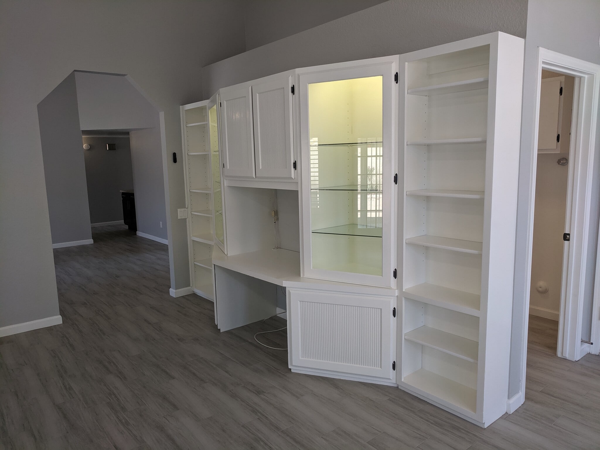 Bookshelf build-in with computer station and Lighted glass display shelves. - 14101 N 78th Dr