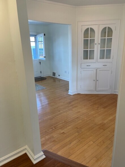 Dining/Sitting Room with original built-in and maple floors. Lots of natural light. Leads to LR. - 2650 S Shore Dr