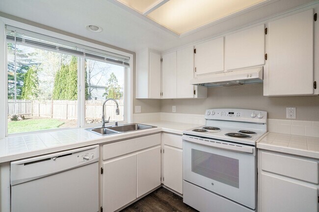 Building Photo - Recently Updated with Wood Laminate Flooring and Fresh Paint