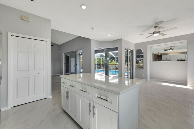 Building Photo - A BOATER'S PARADISE WITH THIS STUNNING 3 BEDROOM, 2 BATH WATERFRONT POOL HOME W/DOCK & BOAT LIFT ...