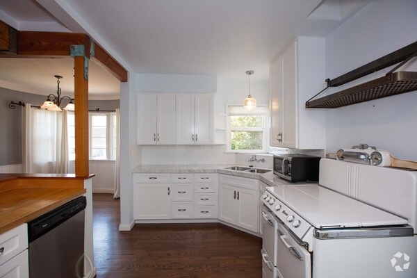 Kitchen features pristine gas 1941 gas stove, butcher block counter as well as carrera marble - 826 21st St