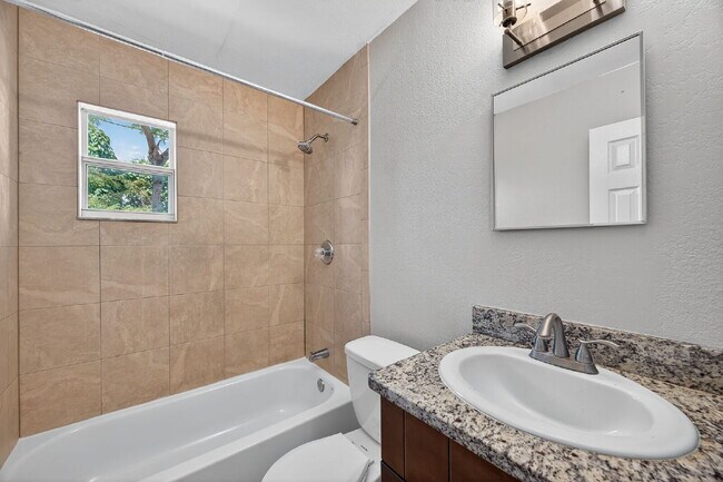 Building Photo - Spacious 2 bed apartment with fenced courtyard, parking, payment plans available for security dep...