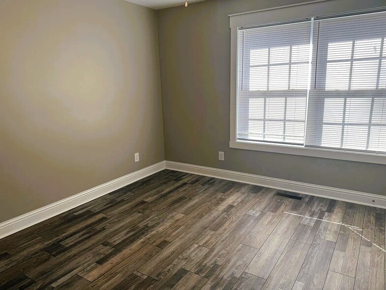 First bedroom with large windows and a closet - 111 Buster Ln