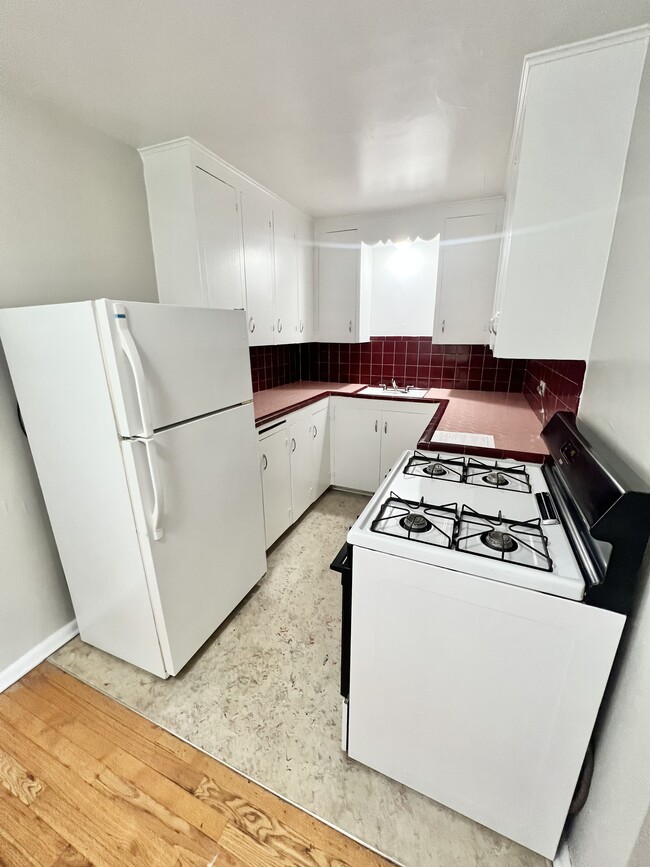 Experience the charm of a well-designed kitchen space, perfect for culinary enthusiasts. - The Birney Apartments