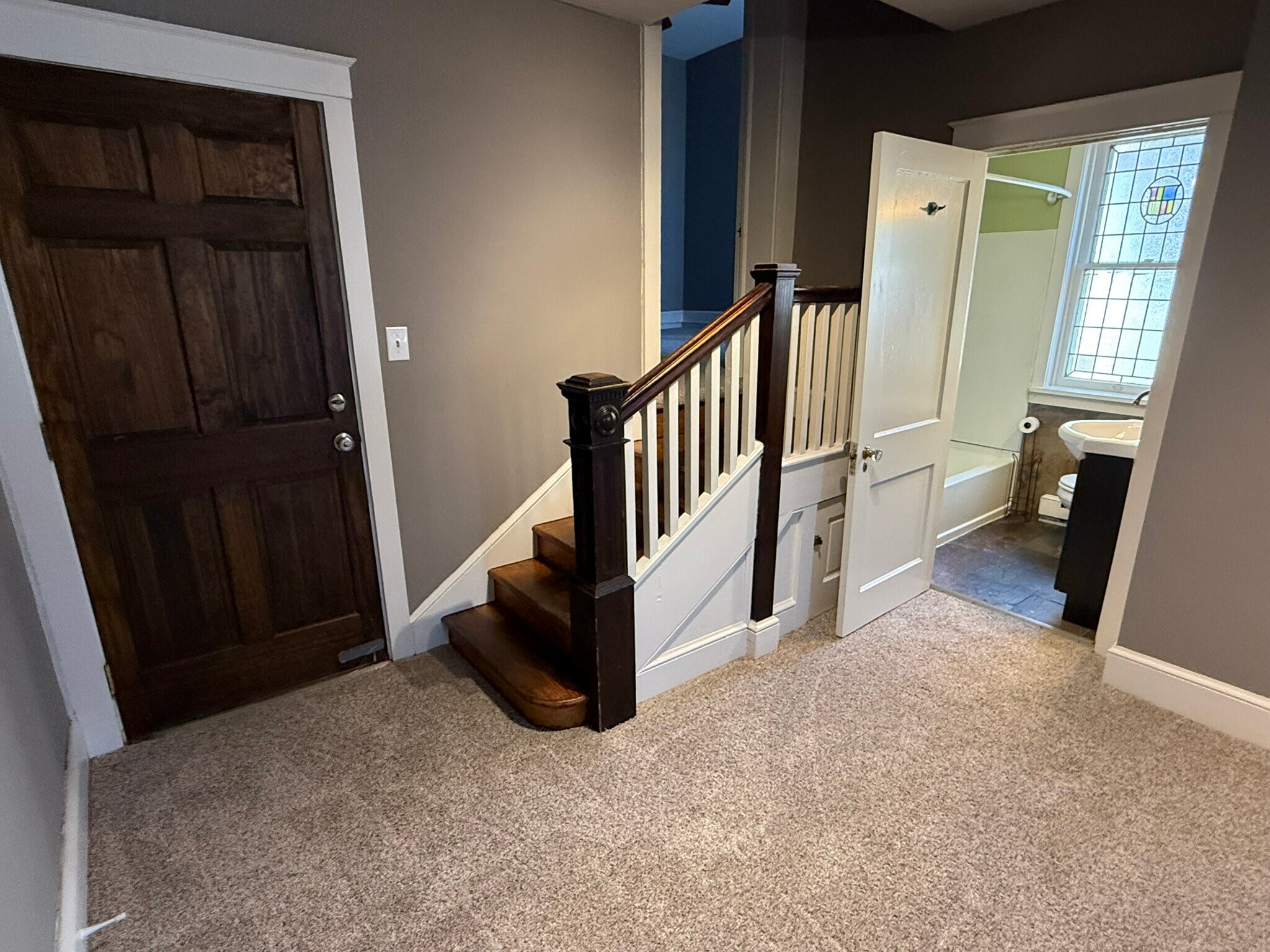 Entry area, bathroom, steps to bedrooms - 218 E Orange St