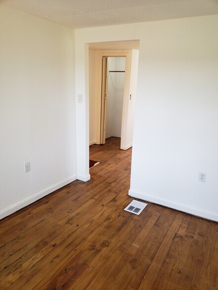Second floor bedroom at front of house. Fresh paint on walls, ceilings and stairwell. - 10106 Wingfield Rd