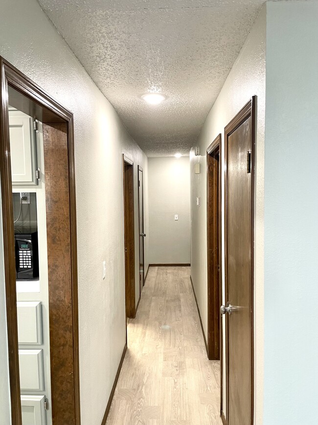 Hallway leading to bedrooms and baths - 8920 Fairfield Greens Dr