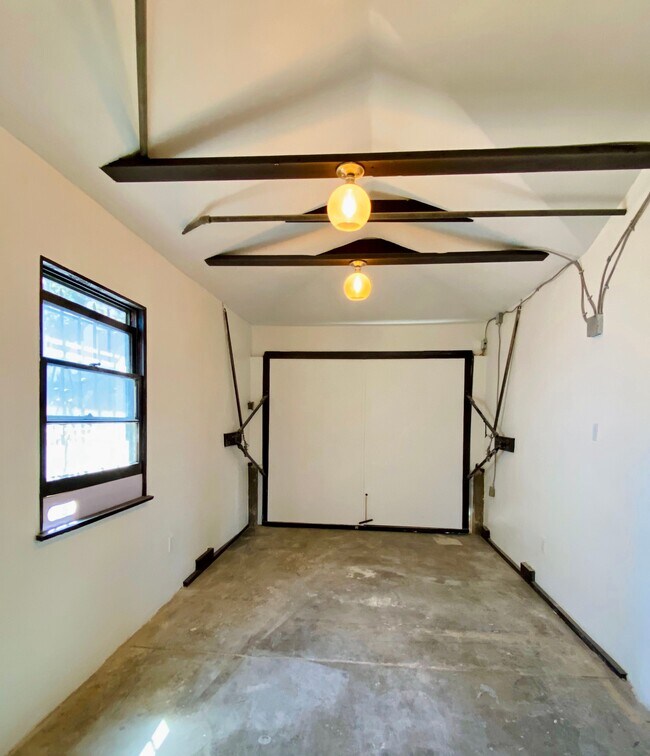 Attached garage with flexible studio, office, or art space. - 1672 Rotary Dr