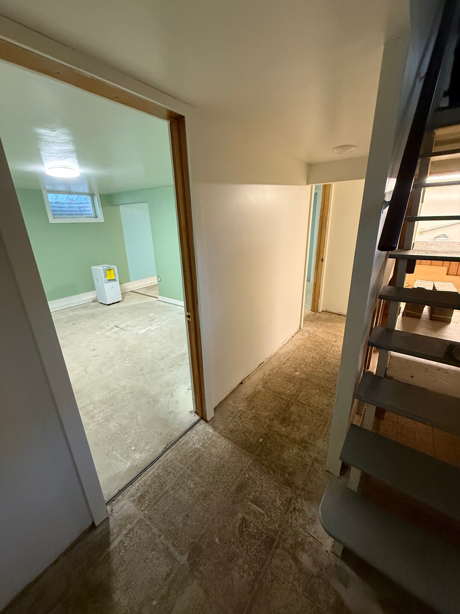 Lower level at bottom of steps. Viewing Bedroom #2. (Floors to be Epoxied in June) - 6820 Rowe Dr