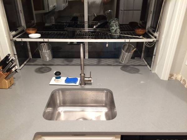 New Quartz countertops in the kitchen with stainless steel under-mout sink. - 6337 Hillman Pl NE