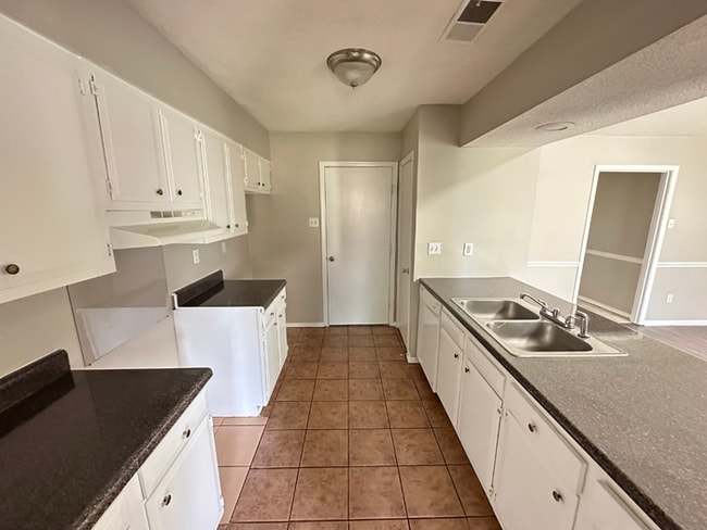 Building Photo - Charming 3BR/2BA Near Southwind | Soaring Vaulted Ceilings, Rustic Fireplace & Garage