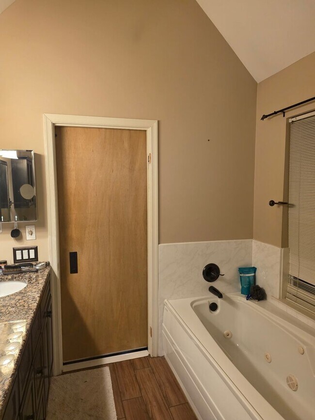 Building Photo - Stunning 3–4 Bedroom Townhome in Private Community | Garage + EV Charger | Deck with Tree Views