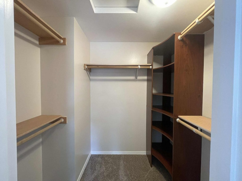 large walk-in closet with five separate shelves and built-in storage organizer - 245 S 126th St