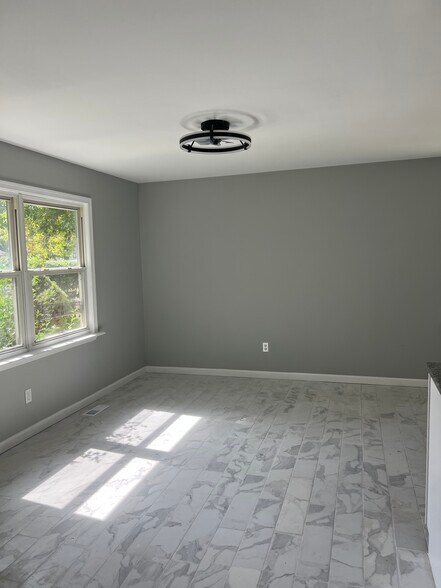 Marble flooring, living / dining room space facing front of the house. open concept to kitchen: - 161 Ronald Rd