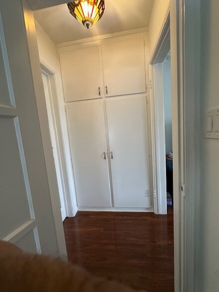 Hall closet, featuring linen pantry, extra storage on top, and beautiful stained glass l ceiling lam - 1859 1/2 Pandora Ave
