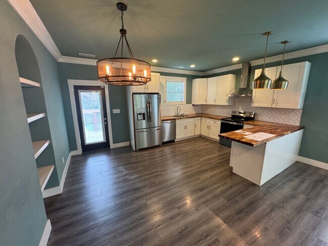 Building Photo - Modern Bungalow Charm: Designer Finishes & Expansive Backyard Living!