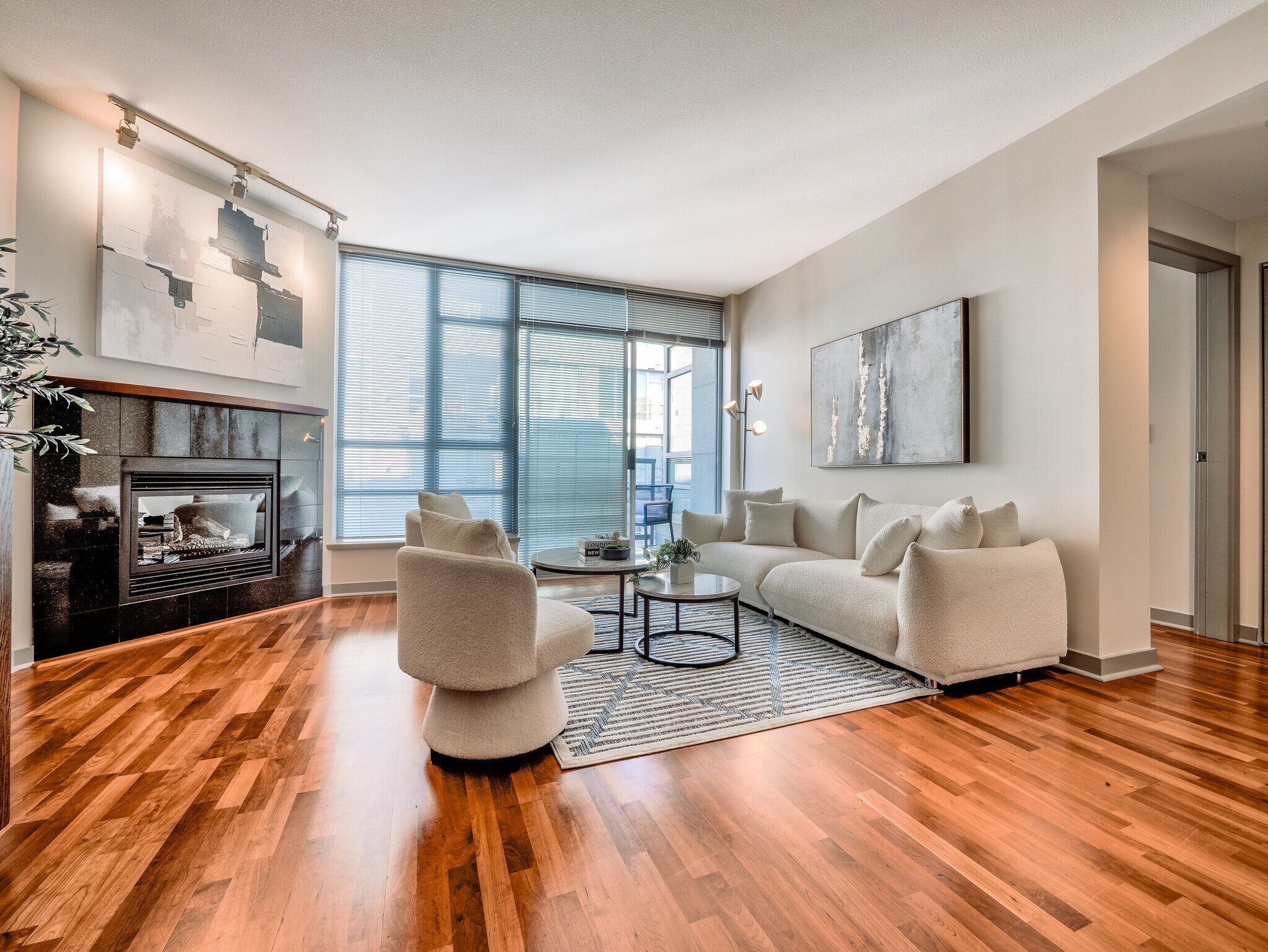Bright, open-concept living area with floor-to-ceiling glass and pristine hardwood floors - 2929 1st Ave