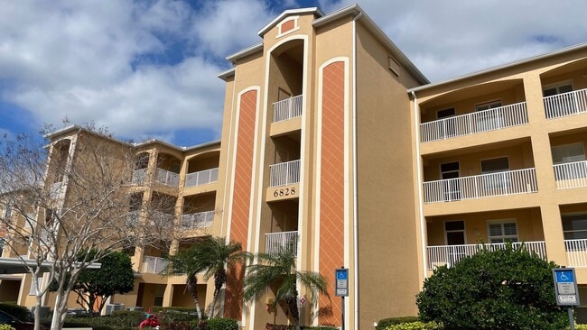 Building Photo - Elevated Luxury at The Terraces – 4th Floor Lake & Golf Course Views! 55+ Community!