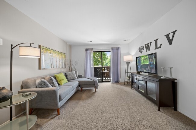 Cozy living room with natural light at Woodland Villa Apartments in Westland, MI. - Woodland Villa Apartments