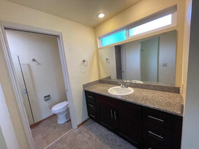 primary bath with a transom functioning window for fresh air and tree view - 280 NW Holly St