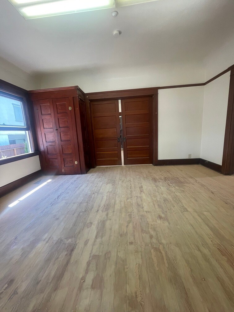 First large bedroom with closet and armoire. - 1135 Magnolia St