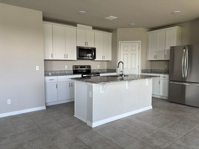 Building Photo - Like-New 4 Bedroom 3 Bath with Pond View & Two Living Spaces — Minutes to South Lake Nona