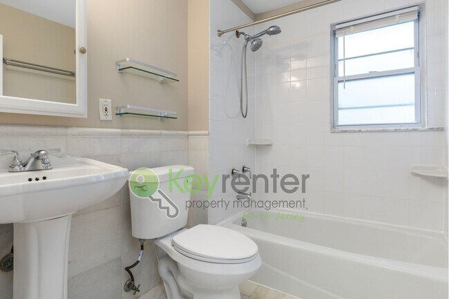 Building Photo - Spacious 3BR Home with Finished Attic, Fenced Yard & Easy NYC Commute – No Broker Fee