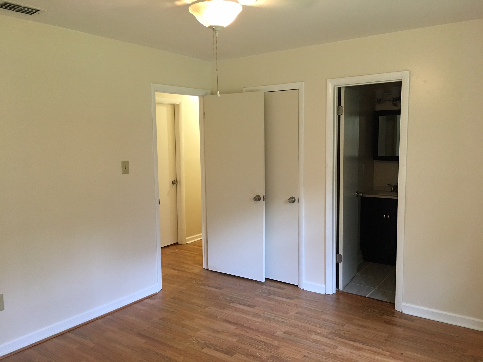 This is a shot from the corner of the master bedroom. You can see the door to the closet and the master bathroom to the right. - 2680 Ballsville Road