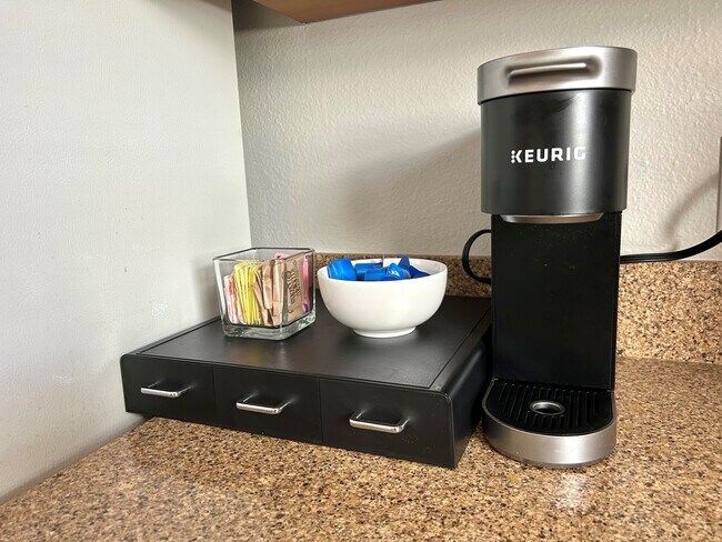 A Keurig coffee machine with a variety of coffee and tea pods. - 6464 Starfish Cv