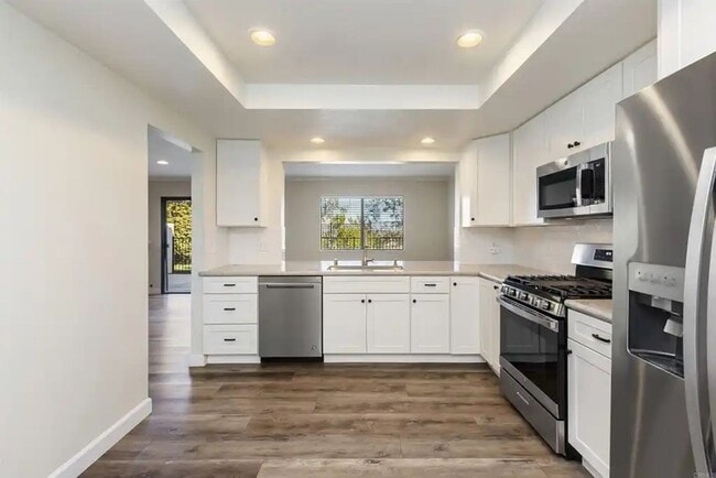 Building Photo - Upgraded La Costa Townhome