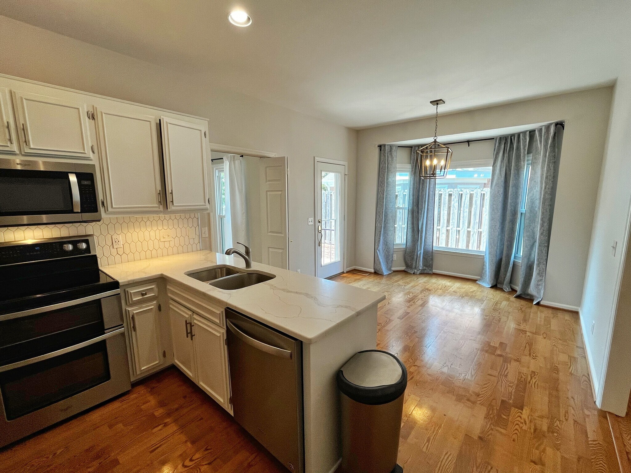 Eat-in kitchen with designer finishes and views of patio area. - 604 Sherbourne Grn