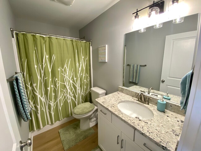Bathroom 2 with full shower, tub, and granite counter tops - 140 Sunburst Villa Dr