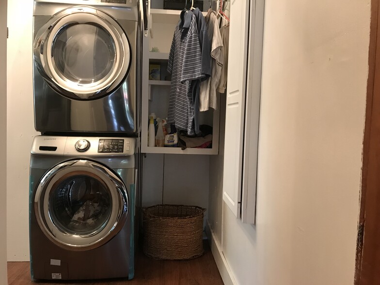 Laundry area includes new top of line Samsung steam washer and dryer with large storage cabinet, clothes hanging bar and pull out folding table - 1407 W Church St