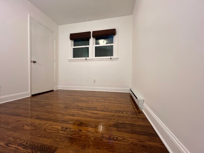 Bedroom with hardwood floors, closet, and heat. - 73 Swannanoa Ave
