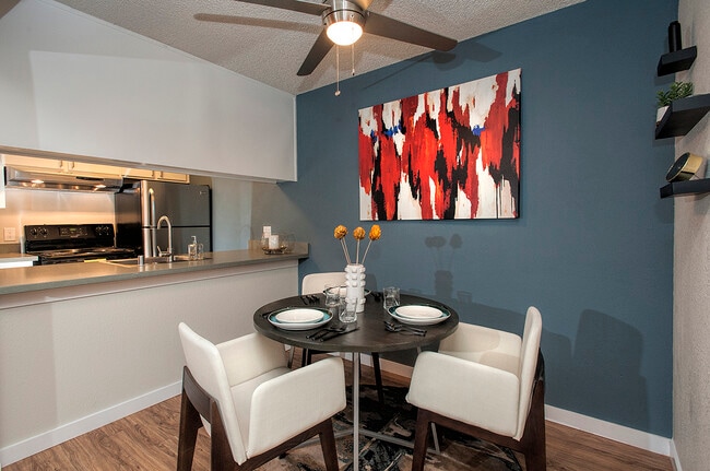 View Of Dining Room With Blue Accent Wall With Decor - Artisan Square