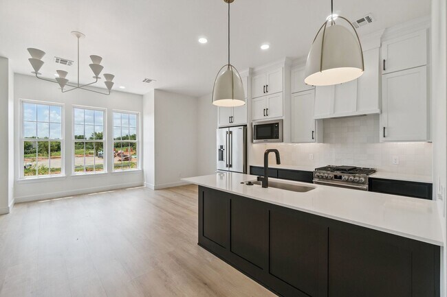 Building Photo - Bright. Clean. Calm. Your Elevated One-Bed...