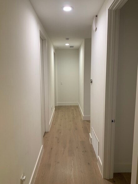 Long hallways connecting 2 bedrooms and one common half bath. Clean lines, museum white paint - 3923 Cole Ave