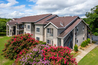 Spacious Apartment Community with Lush Landscaping and Vibrant Flowers at Avonmora in Austin - Avonmora Apartments