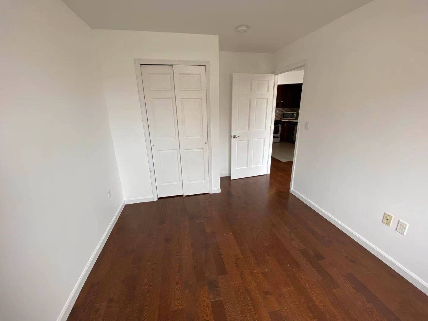 Guest Bedroom facing closet & Living Room - 9411 65th Rd