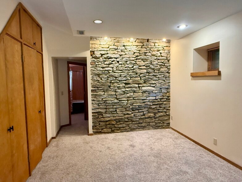 Main Bedroom with exposed stone wall - 2622 Moorman Ave