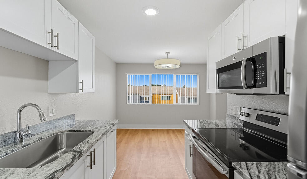 Separate dining room space adjacent to the kitchen - Pacifica Park Apartments