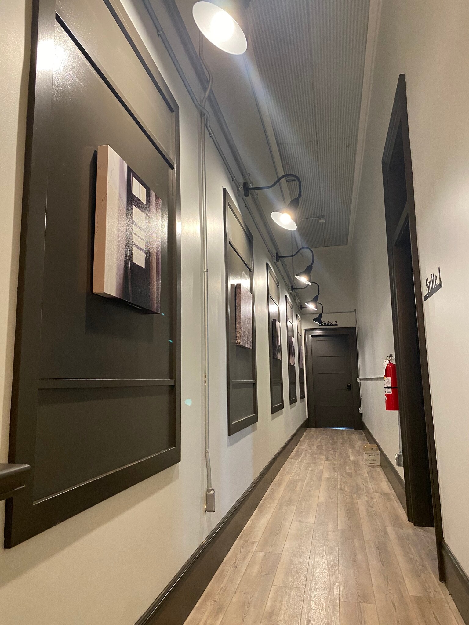 Gallery wall leading to new front door of Suite 2 - 102 S Main St