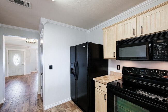 Building Photo - ***APPLICATION CURRENTLY UNDER REVIEW***Modern Elegance: 3-Bedroom Townhome with Wood Flooring, S...