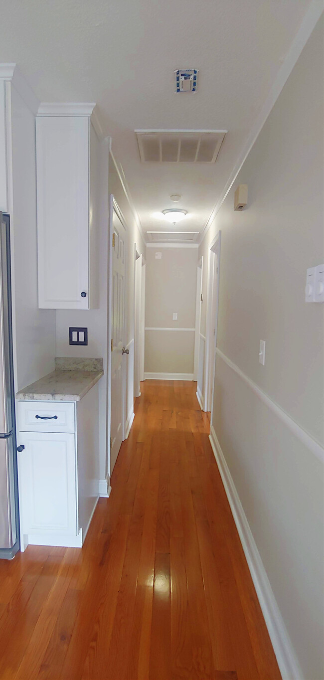 Hall with washer/dryer, bathroom, and one bedroom on the left - 819 Page St