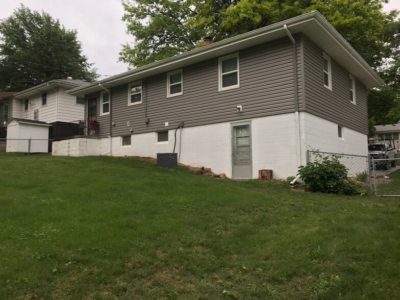 Back view of the home with a fenced in yard - 2616 S 48th Ave