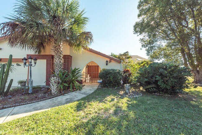 Building Photo - Welcome to this spacious three-bedroom, three-bath home in the heart of Palm Bay