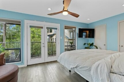 Primary bedroom with large floor to ceiling windows - 1106 W 6th St
